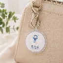 Ronde-plexi-sleutelhanger-aan-tas.webp
